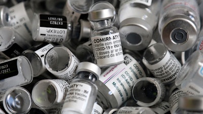 In this file photo dated Saturday, May 15, 2021, empty vials of the Pfizer-BioNTech COVID-19 vaccine lie in a box during a vaccine campaign at the Vaccine Village in Ebersberg near Munich, Germany. Germany's health ministry said Monday that the country may have to discard 3 million doses of expired COVID-19 vaccine by the end of June.