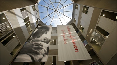 In this July 30, 2013, photo, large banners hang in an atrium at the headquarters of Johnson & Johnson in New Brunswick, N.J. A California appeals court on Monday, April 11, 2022, has ruled Johnson & Johnson must pay $302 million in penalties to the state for deceptively marketing pelvic mesh implants for women.