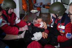 Ambulance paramedics move a civilian wounded in shelling onto a stretcher to a maternity hospital converted into a medical ward in Mariupol, Ukraine, March 2, 2022. A bipartisan group of U.S. lawmakers is calling on the Biden administration to establish field hospitals near Ukraine's border and ramp up medical support for what's expected to be a months-long war of attrition waged by Russia.