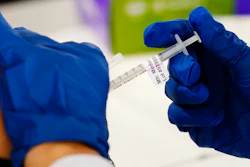 A health worker administers a dose of a Moderna COVID-19 vaccine during a vaccination clinic in Norristown, Pa., Tuesday, Dec. 7, 2021. Moderna on Thursday, April 28, 2022, asked U.S. regulators to authorize low doses of its COVID-19 vaccine for children younger than 6, a long-awaited move toward potentially opening shots for millions of tots by summer.