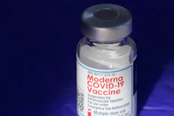 In this March 4, 2021 file photo, a vial of the Moderna COVID-19 vaccine rests on a table at a drive-up mass vaccination site in Puyallup, Wash., south of Seattle. COVID-19 vaccine sales helped Moderna triple its net income in a better-than-expected first quarter. The vaccine maker said Wednesday, May 4, 2022, that revenue from its coronavirus preventive shots jumped to $5.92 billion from $1.73 billion in last year’s quarter, when the vaccines were debuting in most markets.