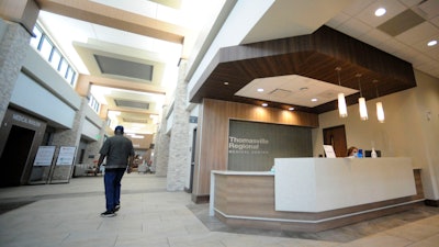 A man walks through the lobby of Thomasville Regional Medical Center in Thomasville, Ala., on Tuesday, May 3, 2022. The hospital is among three in the nation that say they are missing out on federal pandemic relief money because they opened during or shortly before the COVID-19 crisis began.