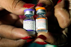 A nurse holds a vial of the Pfizer COVID-19 vaccine for children ages 5 to 11, right, and a vial of the vaccine for adults, which has a different colored label, at a vaccination station in Jackson, Miss., Tuesday, Feb. 8, 2022. U.S. regulators authorized a COVID-19 booster shot for healthy 5- to 11-year-olds on Tuesday, May 17, 2022, hoping an extra vaccine dose will enhance their protection as infections once again are on the rise.