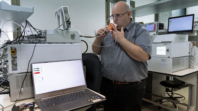 Israeli Harel Hershtik, vice president of strategy and technology at Scentech Medical, demonstrates his company's product, which he says can detect certain diseases by analysing a patient's breath, at the company's office in Rehovet, Israel, May 3, 2022. When he was 20 years old, Hershtik planned and executed a murder, shooting his victim in the head and burying the body in a crime that a quarter of a century later is still widely remembered for its grisly details. Today, he is the brains behind an Israeli health-tech startup with the backing of prominent public figures and deep-pocketed investors.