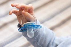 Using a common, commercially available pacifier, the researchers created a system that samples a baby’s saliva through microfluidic channels.