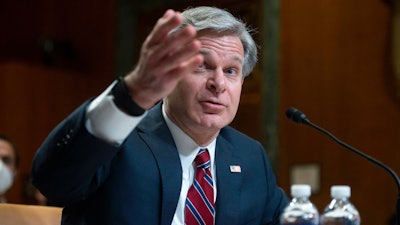 FBI director Christopher Wray testifies during a Senate Appropriations Subcommittee hearing in Washington, on May 25, 2022. Wray says his agents thwarted a planned cyberattack on a Boston children's hospital that was to have been carried out by hackers sponsored by the Iranian government.