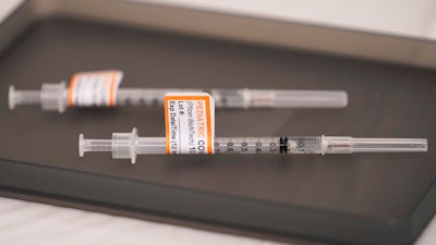 Prepared Pfizer COVID-19 vaccine syringes for children ages 5 to 11 and adults are displayed on a table at Northwest Community Church in Chicago, Dec. 11, 2021. The Biden administration said Thursday, June 2, 2022, that children under 5 may be able to get their first COVID-19 vaccination doses as soon as June 21, if federal regulators authorize shots for the age group, as expected.