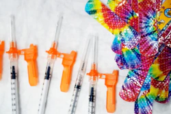 Syringes and colorful bandages are prepared as children from local schools prepare to get COVID-19 vaccines in Pittsfield, Mass., on Monday Dec. 13, 2021.