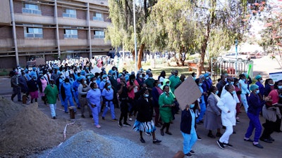 Health workers led by nurses take part in a demonstration over salaries at Parerenyatwa Hospital in Harare, Tuesday, June, 21, 2022. A strike by health workers has left Zimbabwe's major hospitals in near paralysis, putting further strain on a public health system already in a dire state.