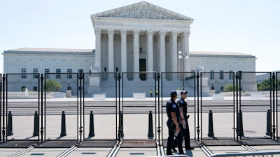 Security works outside of the Supreme Court, Thursday, June 30, 2022, in Washington.