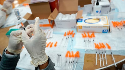 A Northwell Health registered nurse fills a syringe with a COVID-19 vaccine at a pop up vaccination site the Albanian Islamic Cultural Center, April 8, 2021, in the Staten Island borough of New York. The Food and Drug Administration on Thursday, June 30, 2022 recommended that COVID-19 booster shots be modified to better match more recent variants of the coronavirus.
