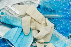 PPE in a medical waste bin.