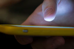 In this Sunday, Aug. 11, 2019, photo, a man uses a cell phone in New Orleans. Quick help for suicidal thoughts and other mental health emergencies may soon be as easy as 9-8-8. The United States’ first nationwide three-digit mental health crisis hotline goes live on Saturday, July 16, 2022.