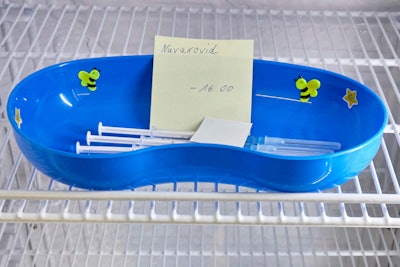 A kidney dish with syringes containing the Novavax COVID-19 vaccine sits in a refrigerator ready for use at a vaccination center in Prisdorf, Germany, Saturday, Feb. 26, 2022.