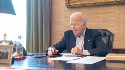 In this image provided by the White House, President Joe Biden speaks with Sen. Bob Casey, D-Pa., on the phone from the Treaty Room in the residence of the White House Thursday, July 21, 2022, in Washington. Biden says he's 'doing great' after testing positive for COVID-19. The White House said Biden is experiencing 'very mild symptoms,' including a stuffy nose, fatigue and cough. He's taking Paxlovid, an antiviral drug designed to reduce the severity of the disease.