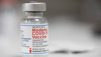 A vial of the Moderna COVID-19 vaccine is displayed on a counter at a pharmacy in Portland, Ore. on Dec. 27, 2021. The Biden administration said Friday it has reached an agreement to buy 66 million doses of Moderna’s next generation of COVID-19 vaccine that specifically targets the highly transmissible omicron variant, ensuring enough supply this winter for everyone who wants the upgraded booster.