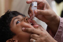 A health worker gives a polio vaccine to a child in Karachi, Pakistan, May 23, 2022. British health authorities on Wednesday, Aug. 10 say they will offer a polio booster dose to children aged 1 to 9 in London, after finding evidence the virus has been spreading in multiple regions of the capital, despite not confirming any cases of the paralytic disease in people.