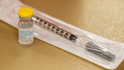 A vial containing the monkeypox vaccine and a syringe is set on the table at a vaccination clinic run by the Mecklenburg County Public Health Department in Charlotte, N.C., Saturday, Aug. 20, 2022.