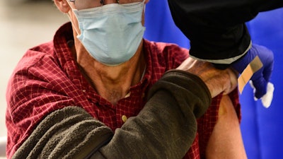 A man receives a flu shot in Brattleboro, Vt., on Tuesday, Oct. 26, 2021. Doctors have a message for vaccine-weary Americans: Don't skip your flu shot this fall 2022.