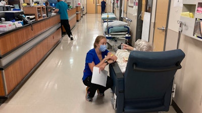 A nurse talks to a patient in the emergency room at Salem Hospital in Salem, Ore., on Aug. 20, 2021.
