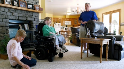 This undated photo shows Terry Horgan with his parents in the family's Montour Falls, N.Y., home.