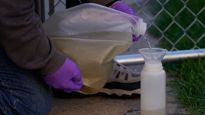 Ryan Dupont, Utah State University Professor of Civil & Environmental Engineering, collects sewage samples from the dorms at Utah State University Wednesday, Sept. 2, 2020, in Logan, Utah, to test for COVID-19.
