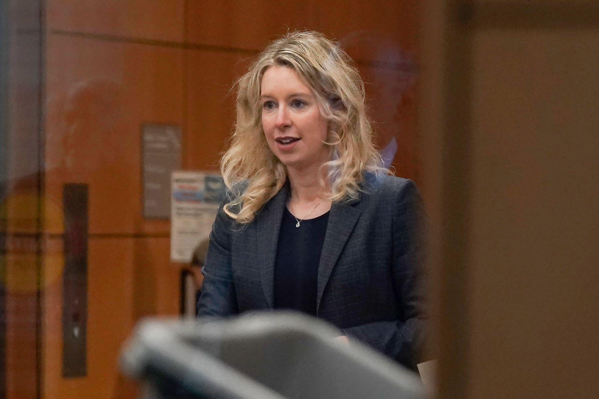 Theranos founder and CEO Elizabeth Holmes, center, walks into federal court with her partner Billy Evans, right, and her parents in San Jose, Calif., Friday, Nov. 18, 2022. A federal judge will decide whether Holmes should serve a lengthy prison sentence for duping investors and endangering patients while peddling a bogus blood-testing technology.