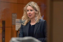 Theranos founder and CEO Elizabeth Holmes, center, walks into federal court with her partner Billy Evans, right, and her parents in San Jose, Calif., Friday, Nov. 18, 2022. A federal judge will decide whether Holmes should serve a lengthy prison sentence for duping investors and endangering patients while peddling a bogus blood-testing technology.