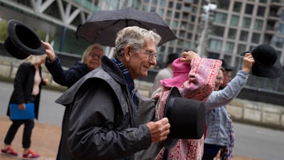 Campaigners took their hat off in a show of respect for people who took their own lives in The Hague, Netherlands, on Oct. 10, 2022.