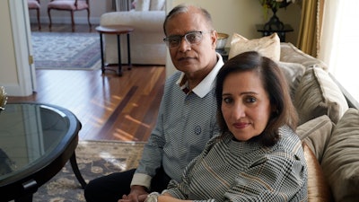 Vinita Rampuria, front, and her husband Ashoke Rampuria, of Acton, Mass., sit for a photograph, Tuesday, April 4, 2023, at their home in Acton. The couple, whose son has struggled with mental illness and has been in and out of mental health care facilities for more than a decade, are supporting efforts in Massachusetts to create a new law that would let judges order the severely mentally ill into mandatory outpatient care after being released from a mental health institution.
