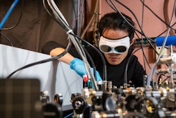Qizhong Liang, a PhD candidate in JILA and the Department of Physics at the University of Colorado Boulder, demonstrates how the laser-based breathalyzer works, in the Ye lab at JILA.
