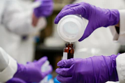Eva Stebel, water researcher, pours a water sample at the EPA Center for Environmental Solutions and Emergency Response, Cincinnati, Feb. 16, 2023.