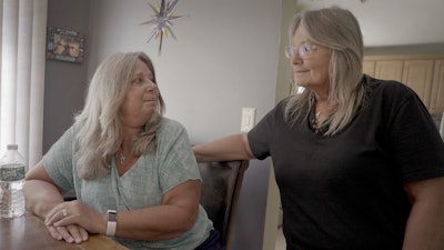 Mary Miller-Duffy, left, sits next to her wife, Sue Duffy, in their home in Newburgh, N.Y., on Aug. 2, 2023.
