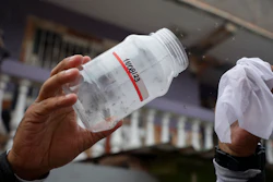 A Doctors Without Borders' worker releases laboratory-bred mosquitoes infected with bacteria that interrupt the transmission of dengue, in Tegucigalpa, Honduras, Thursday, Aug. 24, 2023.