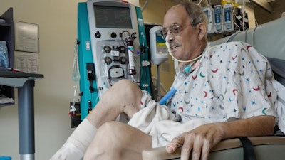 In this image from video provided by the University of Maryland School of Medicine, Lawrence Faucette, a pig heart transplant patient, works with a physical therapist at the school's hospital in Baltimore, Md., on Wednesday, Oct. 18, 2023.