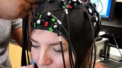 University of Houston researcher Stacey Gorniak dons the neuroimaging device used in the study. The device uses infrared light to measure brain activity during tasks that involve memory.