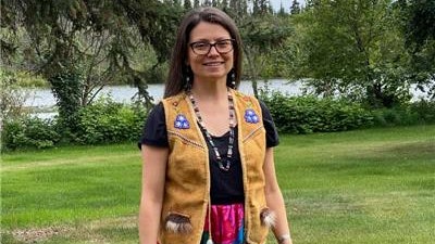 Dr. Allison Kelliher, wearing a moose hide vest gifted to her by her family, uses her training to promote better cardiovascular health for American Indian and Alaska Native women.