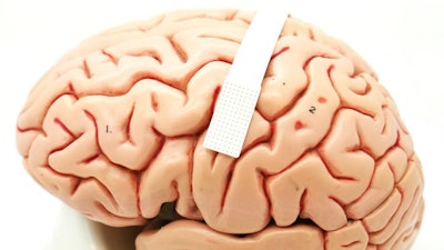 A device no bigger than a postage stamp (dotted portion within white band) packs 128 microscopic sensors that can translate brain cell activity into what someone intends to say.