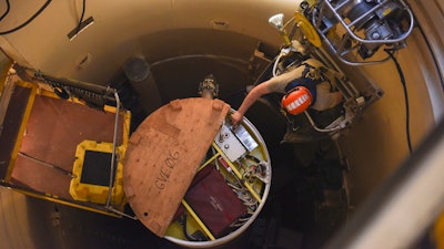 In this image provided by the U.S. Air Force, Airman 1st Class Jackson Ligon, 341st Missile Maintenance Squadron technician, examines the internals of an intercontinental ballistic missile during a simulated electronic launch Minuteman test Sept. 22, 2020, at a launch facility near Malmstrom Air Force Base in Great Falls, Mont.