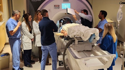 In this photo provided by the WVU Rockefeller Neuroscience Institute, an Alzheimer’s patient undergoes focused ultrasound treatment with the WVU RNI team in Morgantown, W.Va., on Oct. 17, 2023.