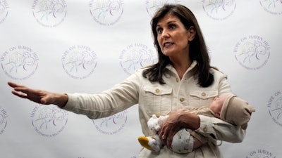 Republican presidential candidate former UN Ambassador Nikki Haley holds a patient's baby while speaking at Hope on Haven Hill, a wellness center, Wednesday, Jan. 17, 2024, in Rochester, N.H.