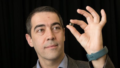 Professor Hamdi Torun pictured with the contact lens.