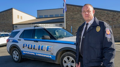 Marion Police Chief John Clair poses outside the Marion Police Department building, Monday, Feb. 5, 2024, in Marion, Va. Clair, chief of the small Appalachian town, spends his days consumed by a growing problem: the frequency with which his officers are tapped to detain, transport and wait in hospitals with people in the throes of a mental health crisis.