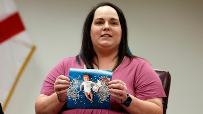 Elizabeth Goldman holds a photo of her daughter, Zari Grace, as she tells her story to Secretary of U.S. Health and Human Services, Xavier Becerra who hosted a panel discussion with families directly affected by the Alabama Supreme Court Court decision, Tuesday, Feb. 27, 2024, in Birmingham, Ala.