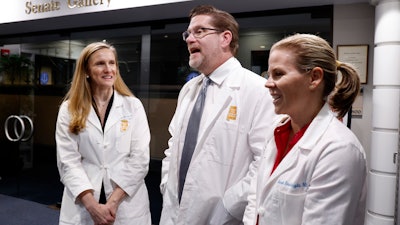 Dr. Mamie McLean, left, Dr. Michael Allemand, center, and Dr. Janet Bouknight, right, react after the Senate passed SB159 bill (IVF Fertility Bill), Wednesday, March 6, 2024, in Montgomery, Ala.