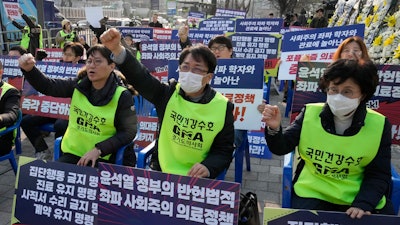 Members of the Gyeonggi Province Medical Association stage a rally against the government's medical policy near the presidential office in Seoul, South Korea, Wednesday, March 13, 2024. South Korea's government criticized senior doctors at a major hospital Tuesday for threatening to resign in support of the weekslong walkouts by thousands of medical interns and residents that have disrupted hospital operations. The banners read 'Stop President Yoon Suk Yeol government's medical policy.'