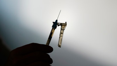 A syringe is prepared at a clinic in Norristown, Pa., Dec. 7, 2021. The Environmental Protection Agency finalized a rule Thursday, March 14, 2024, imposing stricter limits on a chemical used to sterilize medical equipment after finding a higher-than-expected cancer risk at facilities that use ethylene oxide to clean billions of devices including catheters and syringes.