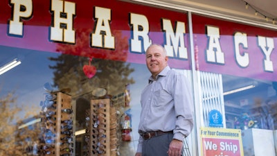 Craig Jones stands for a portrait in front of Basin Pharmacy in Basin, Wyo., on Wednesday, Feb. 21, 2024. It’s the key health care access point for the town of about 1,300 people and the surrounding area.