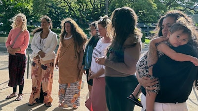 Supporters of a lawsuit challenging a Hawaii midwife licensure law gather outside a courthouse in Honolulu on Monday, June 10, 2024.