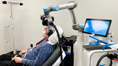 Brain electrical responses can be studied by measuring EEG simultaneously with brain stimulation. In the picture, a robotic arm holds the TMS coil.